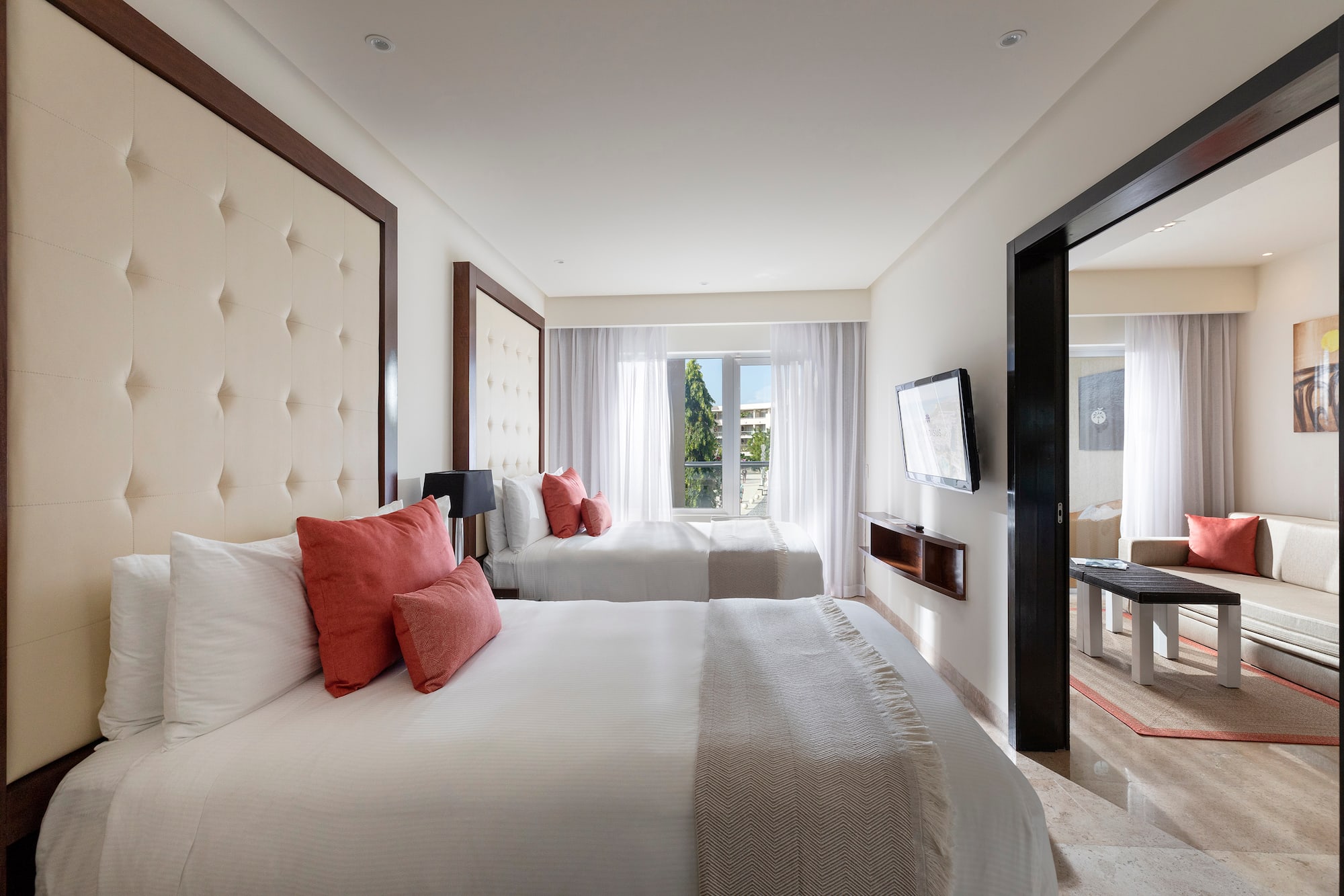 a room with two beds and a television