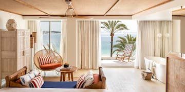 a room with a view of the ocean and a beach