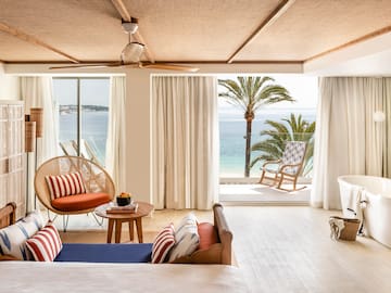 a room with a view of the ocean and a beach