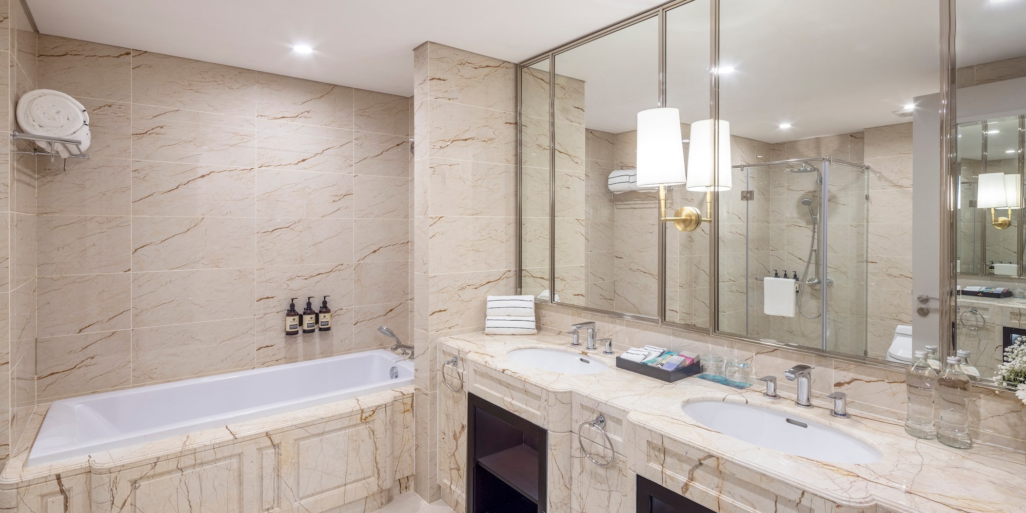 a bathroom with marble countertops and a tub