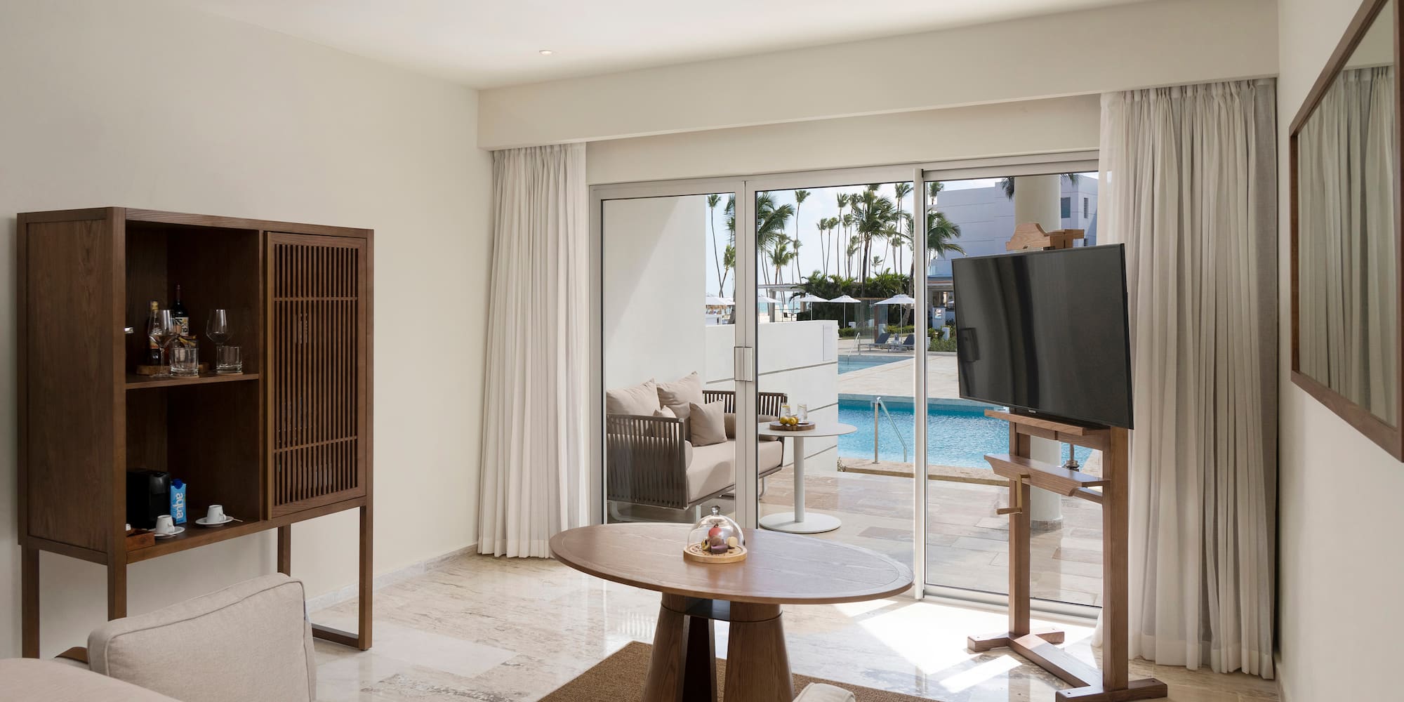 a living room with a television and a pool