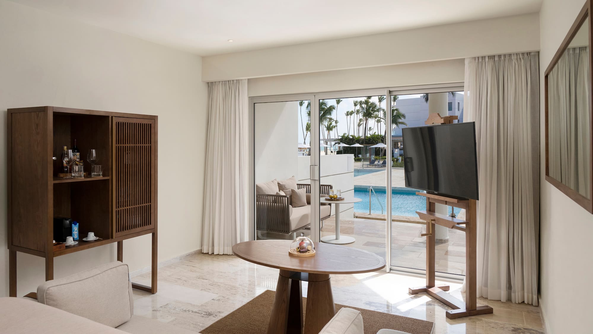 a living room with a television and a pool