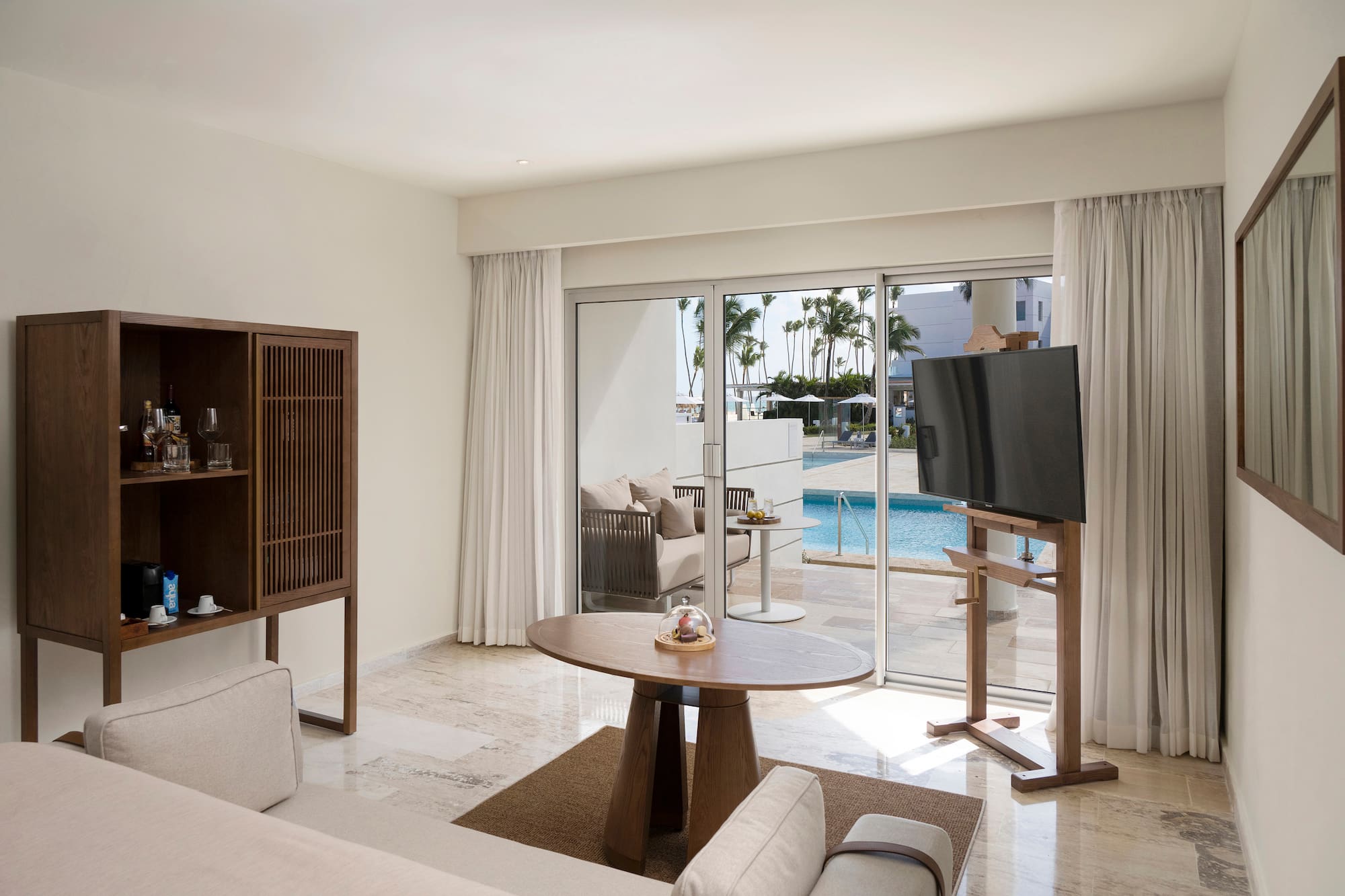 a living room with a television and a pool