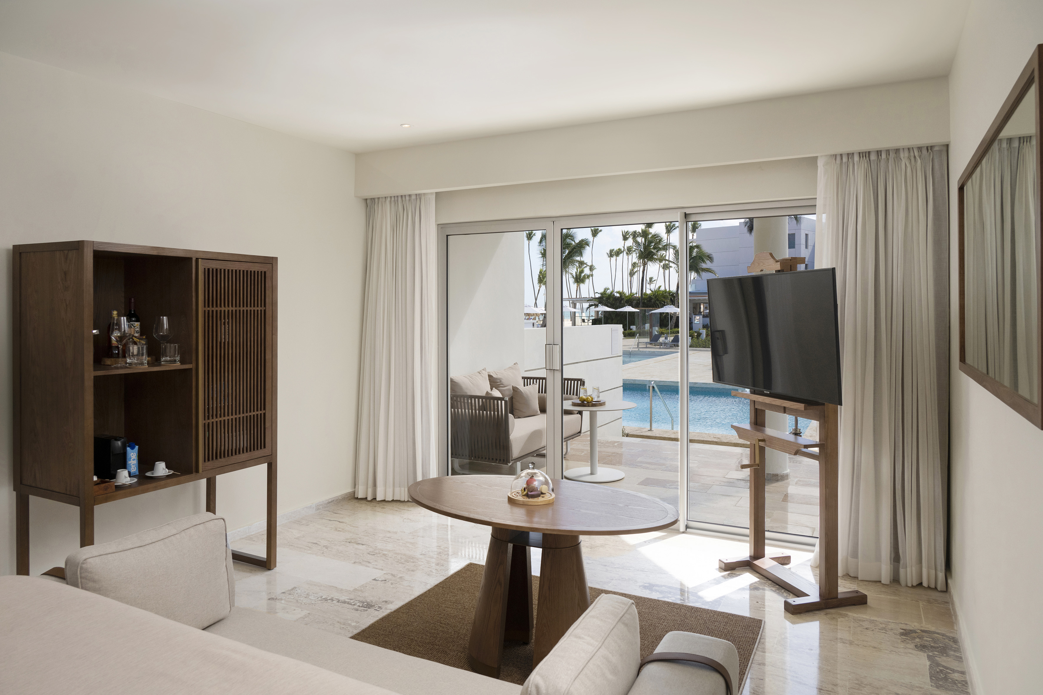 a living room with a television and a pool