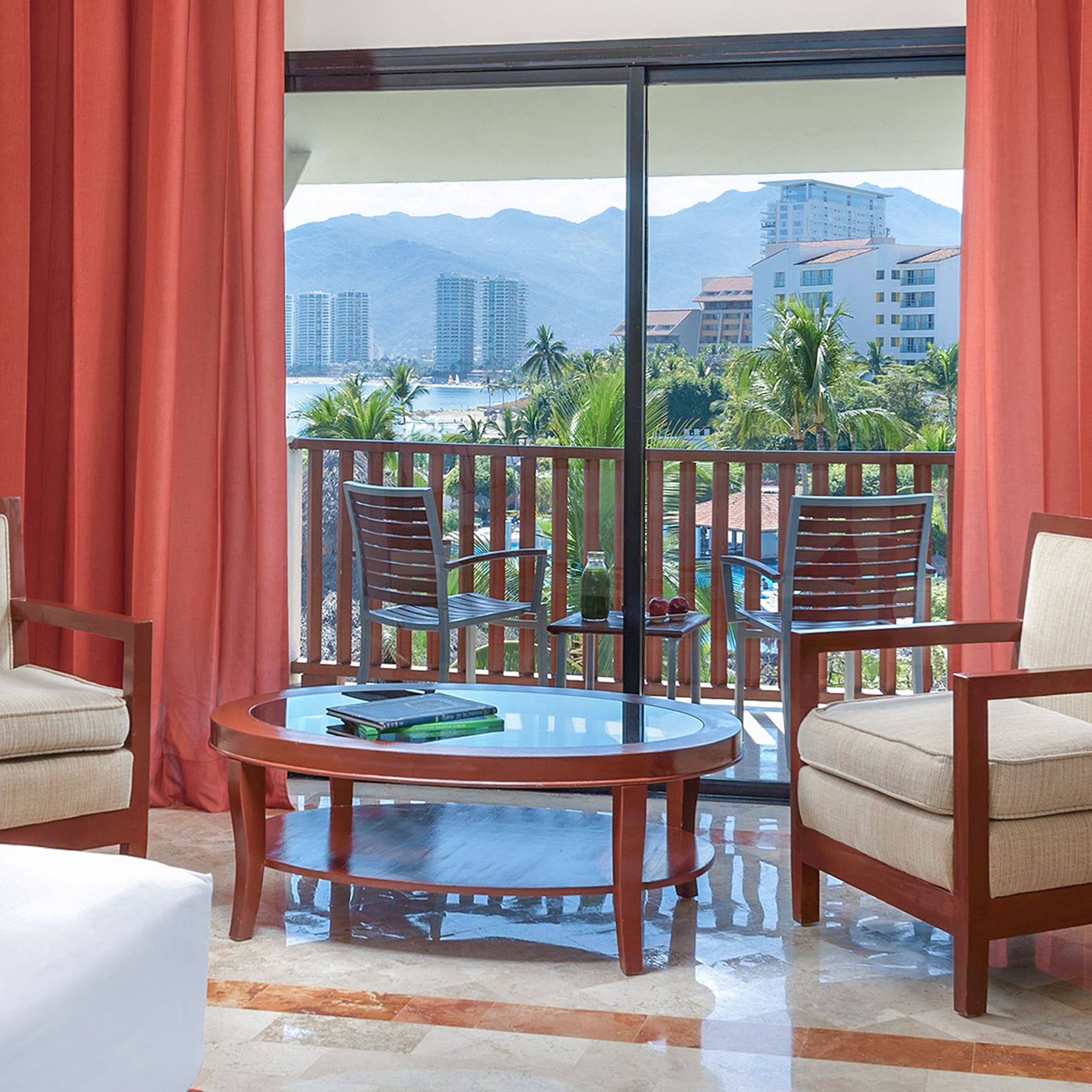 a room with a glass door and chairs