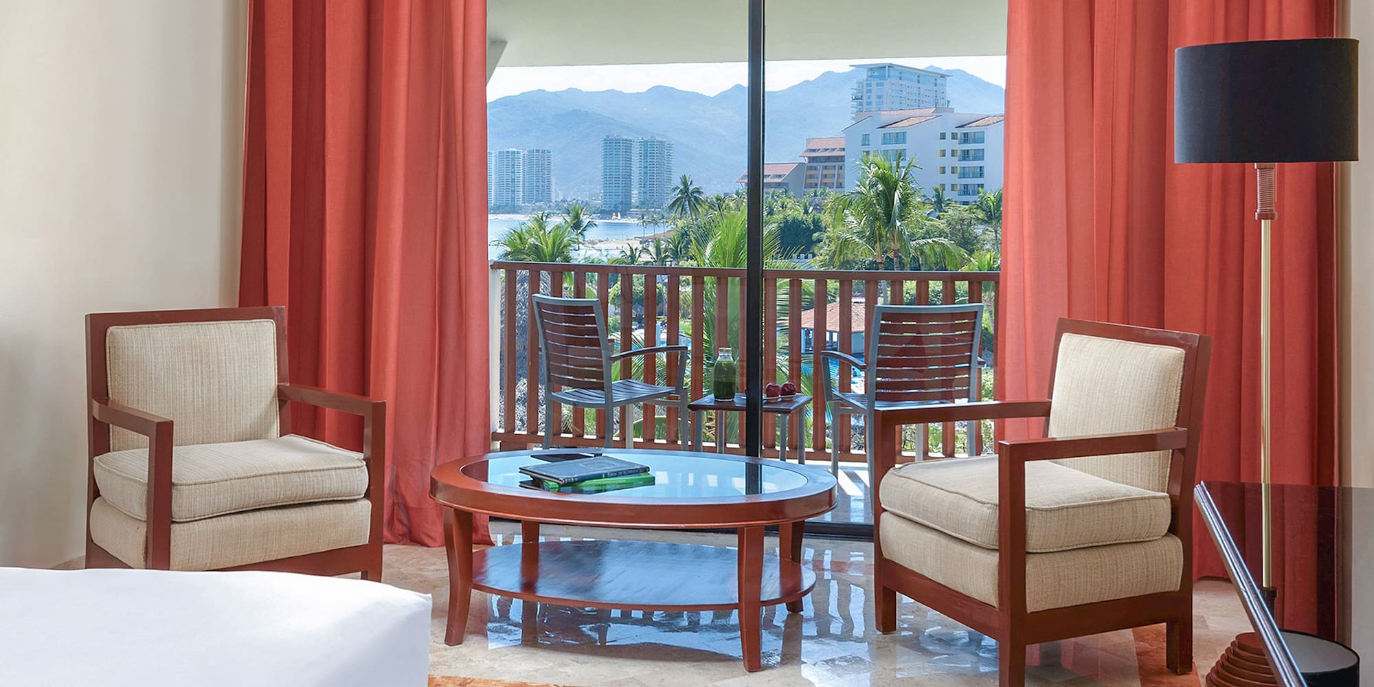 a room with a glass door and chairs