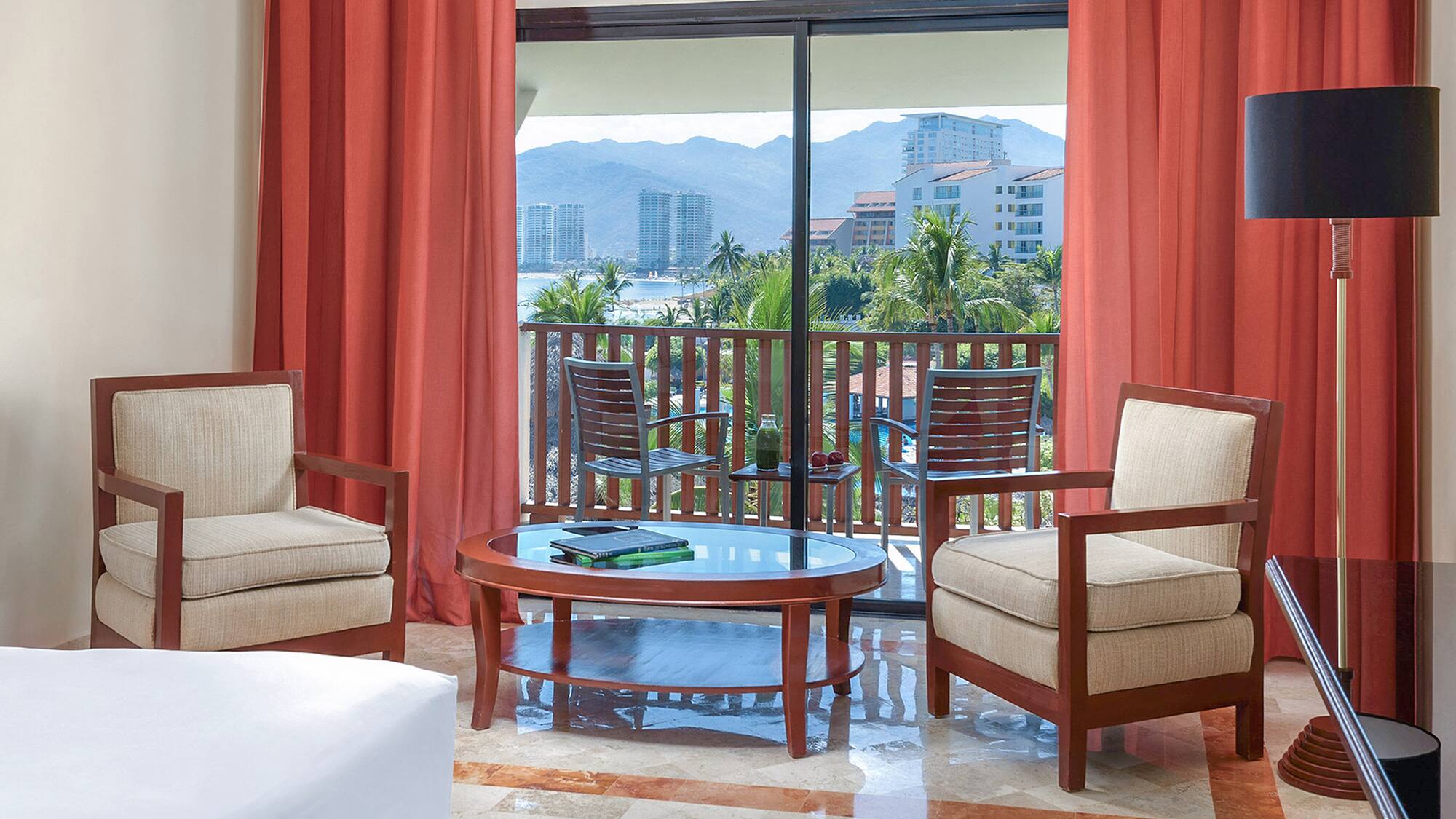 a room with a glass door and chairs