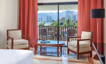a room with a glass door and chairs