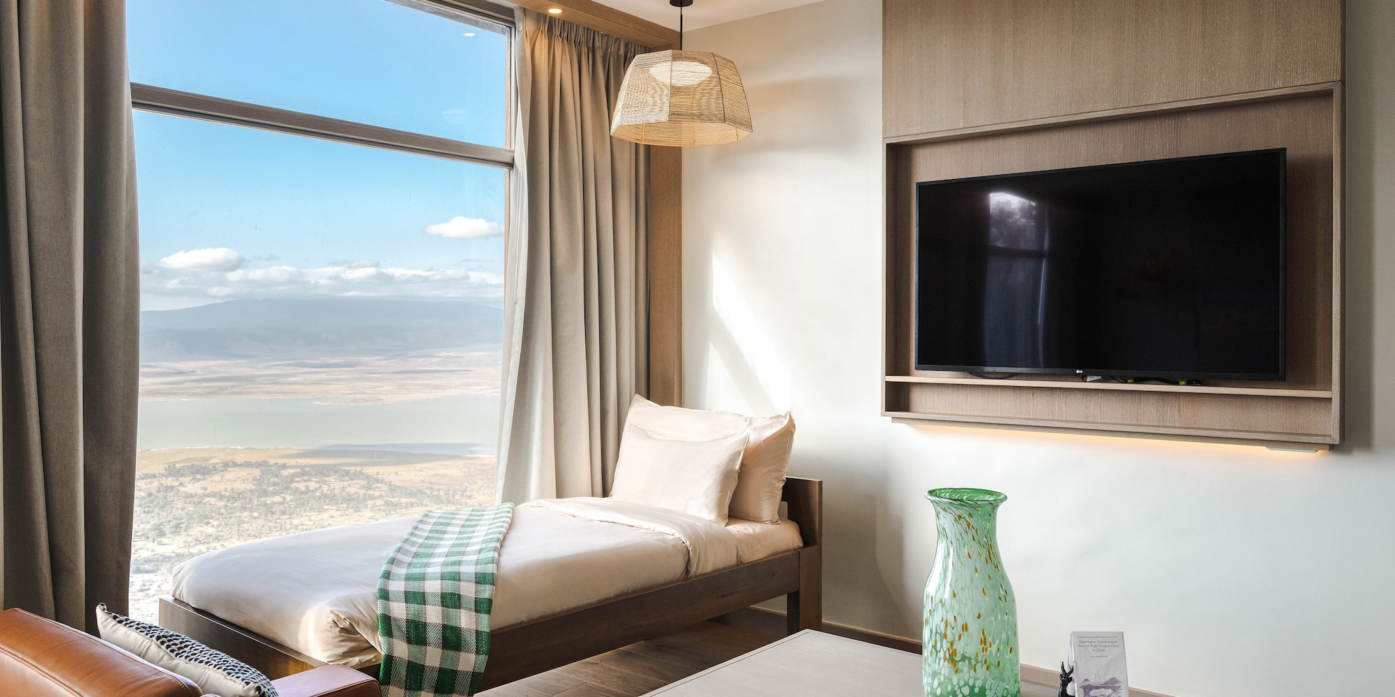 a room with a bed and a television