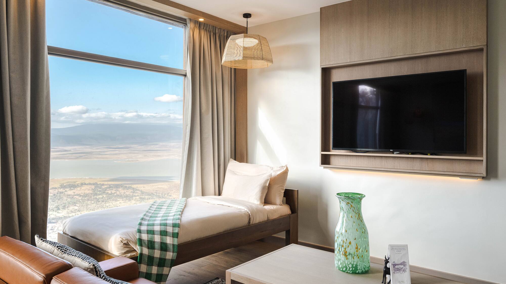 a room with a bed and a television