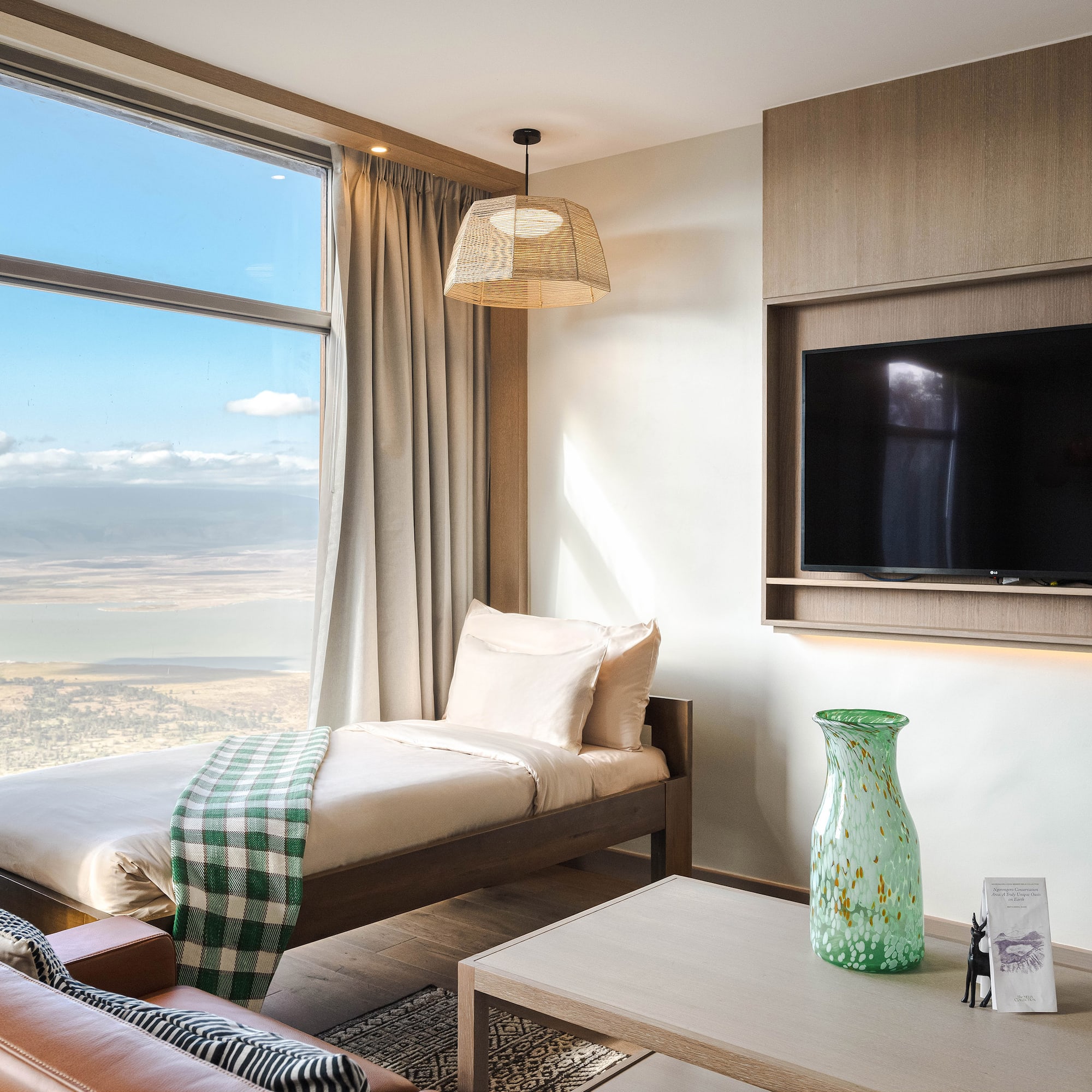 a room with a bed and a television