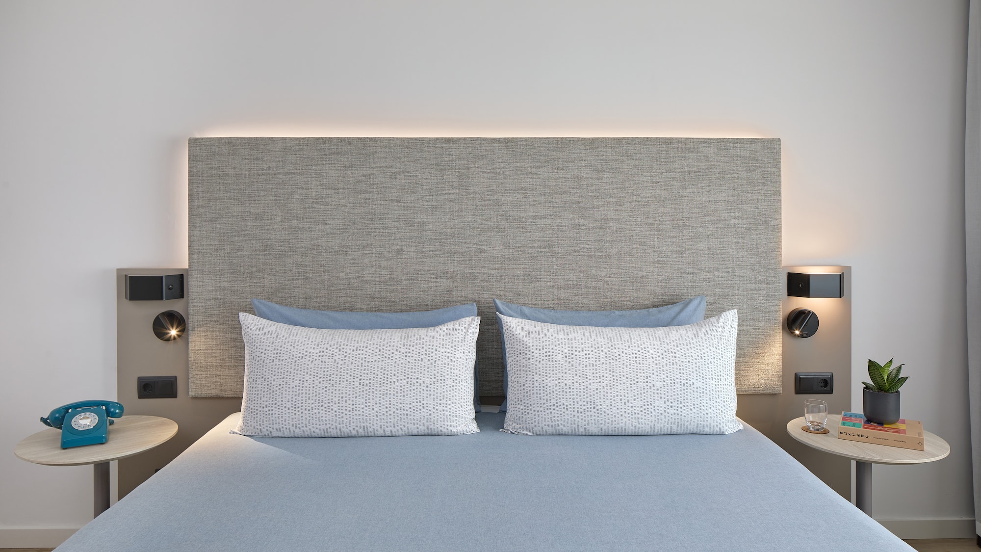 a bed with a headboard and a lamp