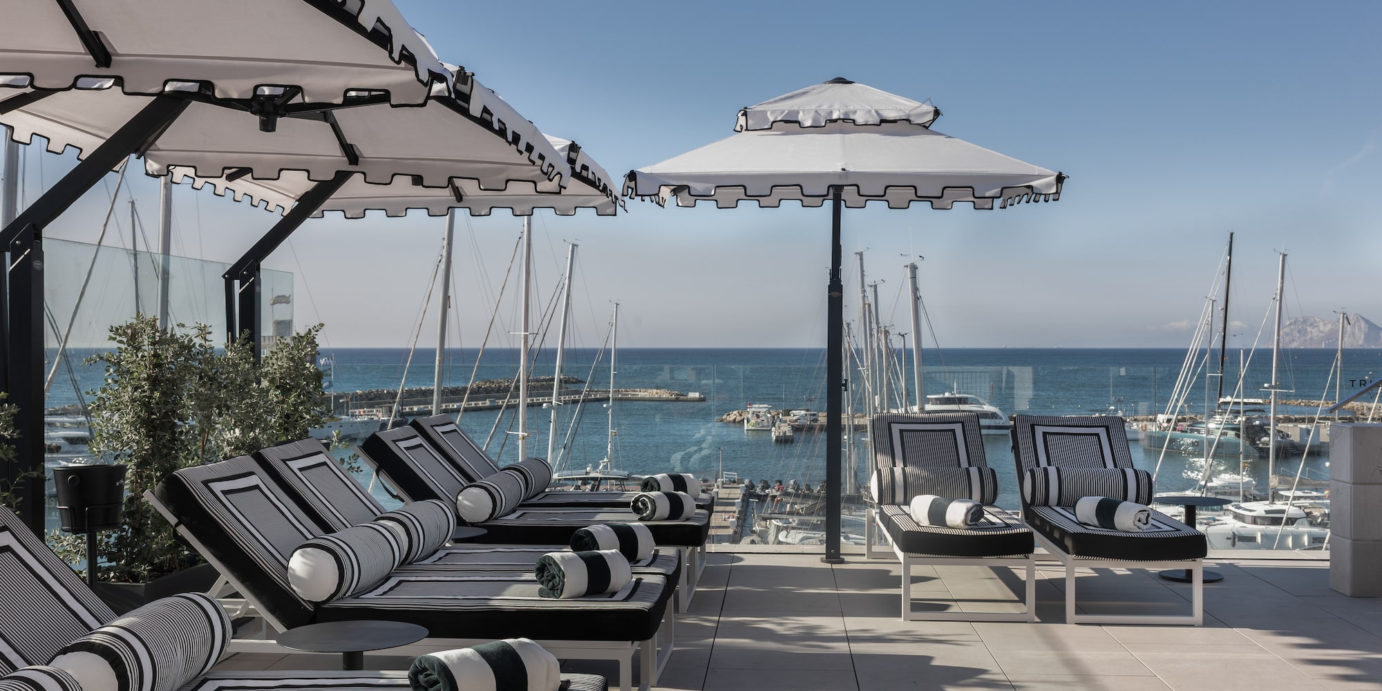 a group of chairs and umbrellas on a patio
