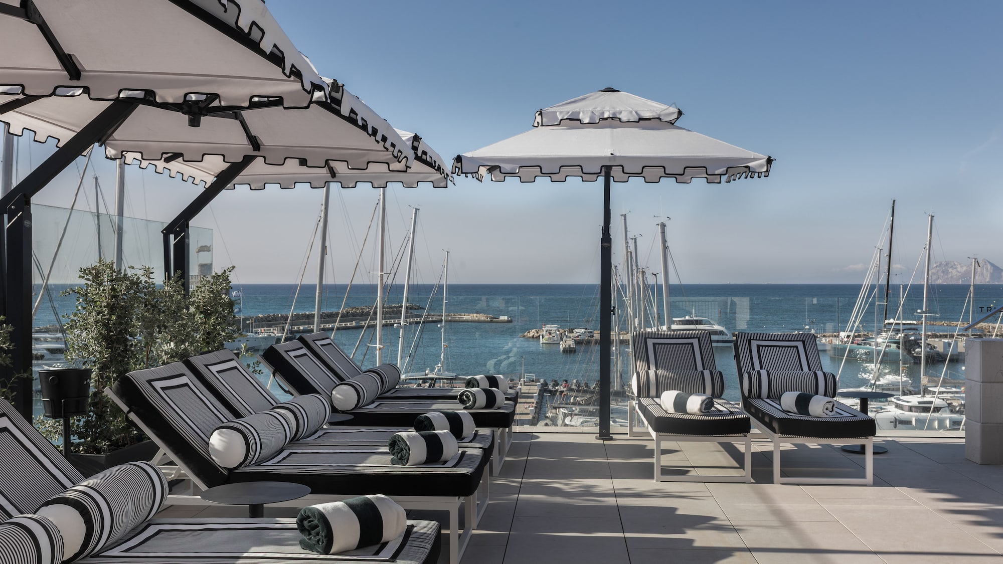 a group of chairs and umbrellas on a patio