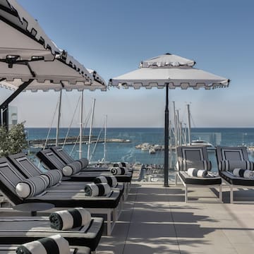 a group of chairs and umbrellas on a patio