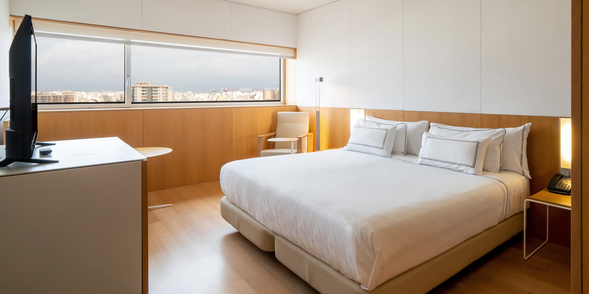 a bedroom with a large bed and a table