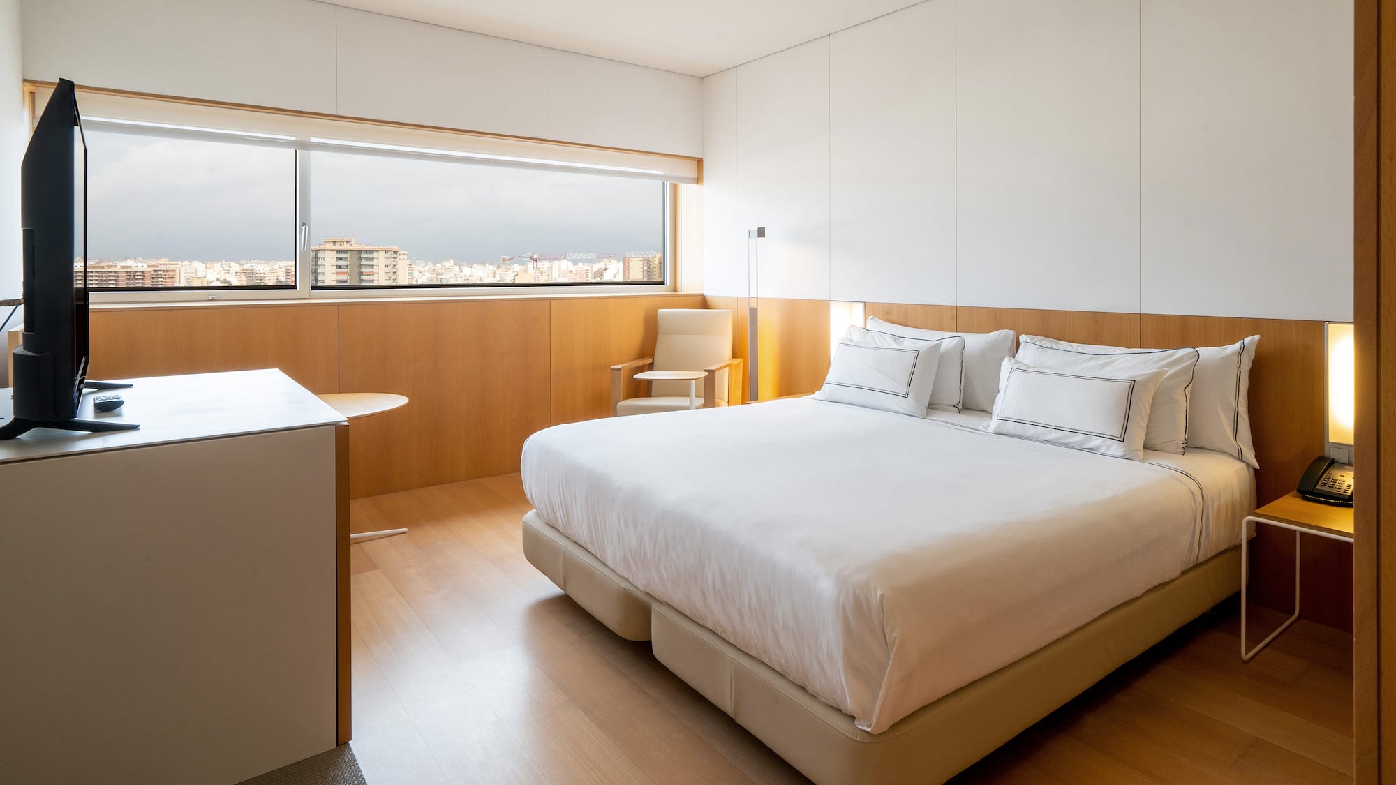 a bedroom with a large bed and a table