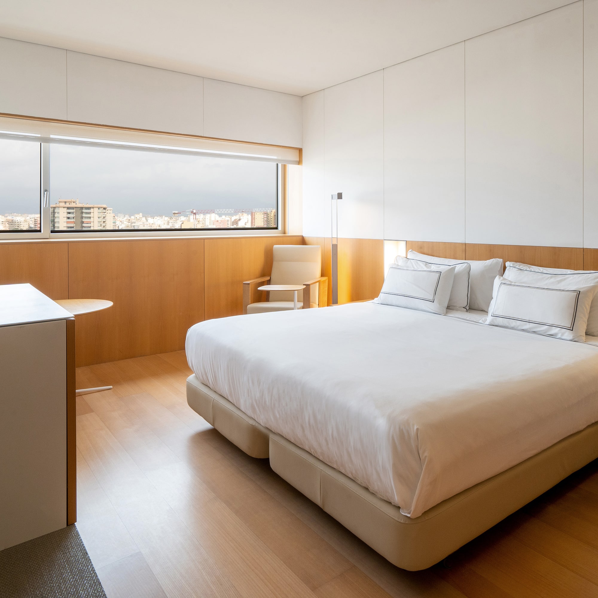 a bedroom with a large bed and a table