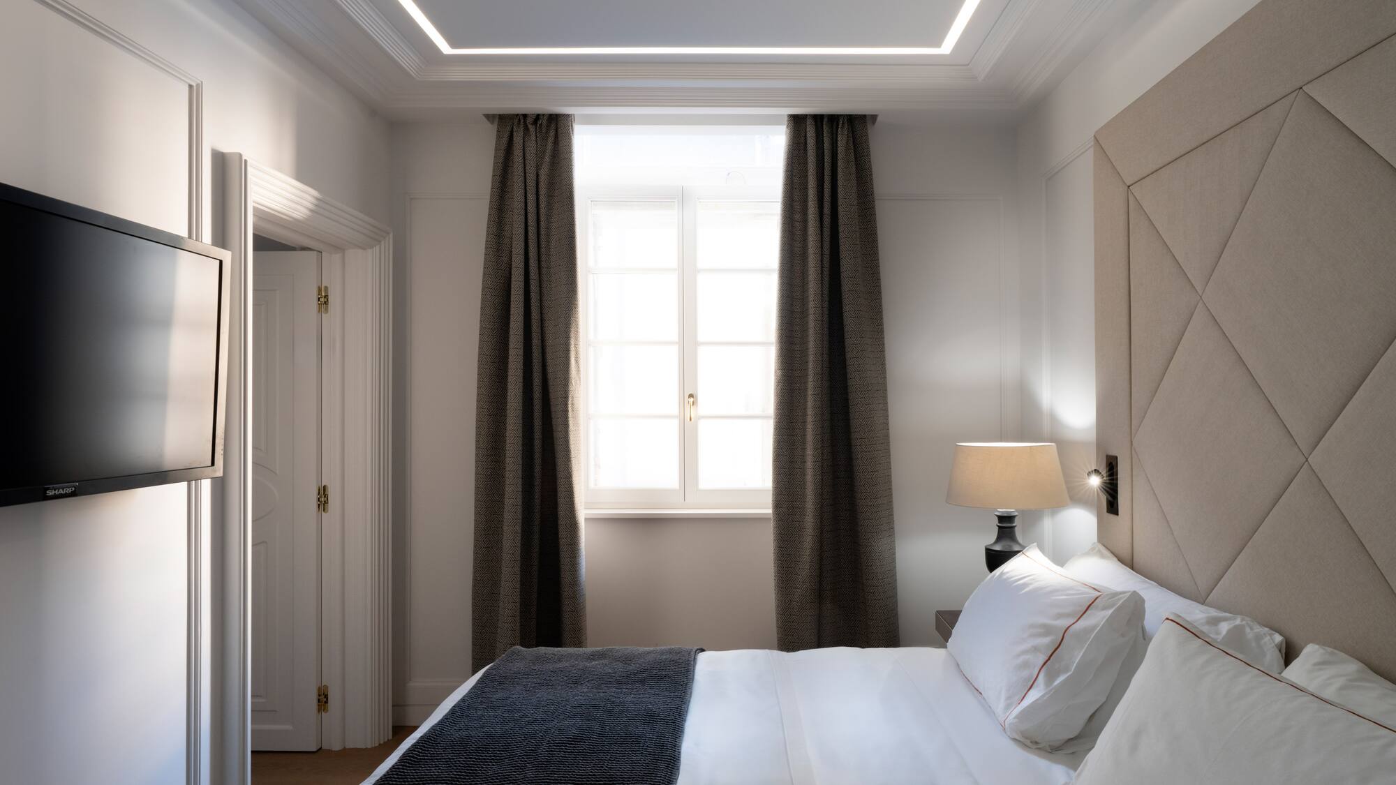 a bed with a lamp and a window