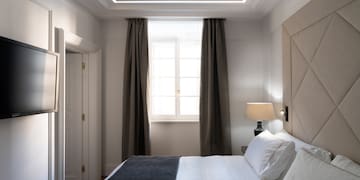 a bed with a lamp and a window