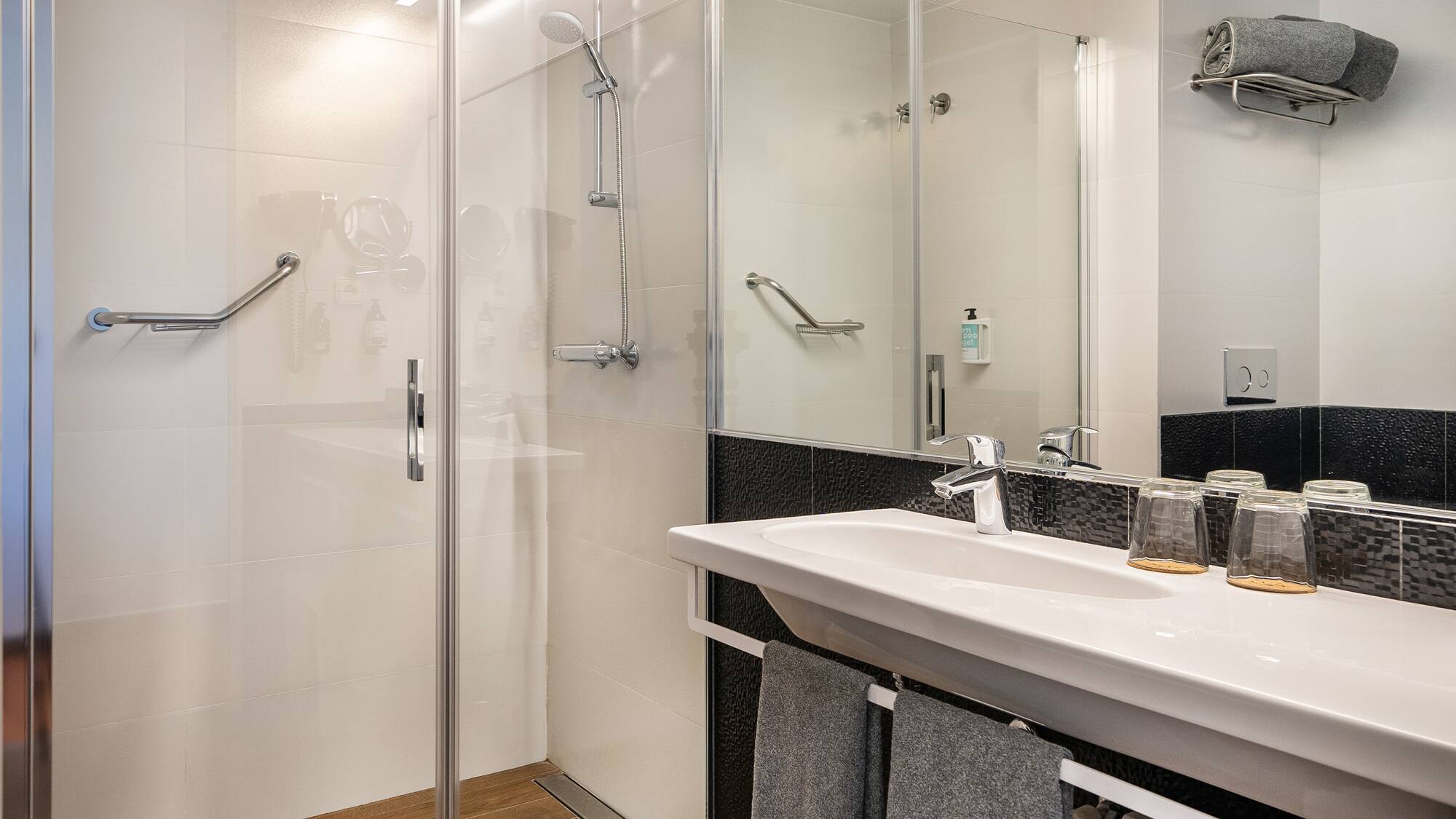 a bathroom with a shower and sink