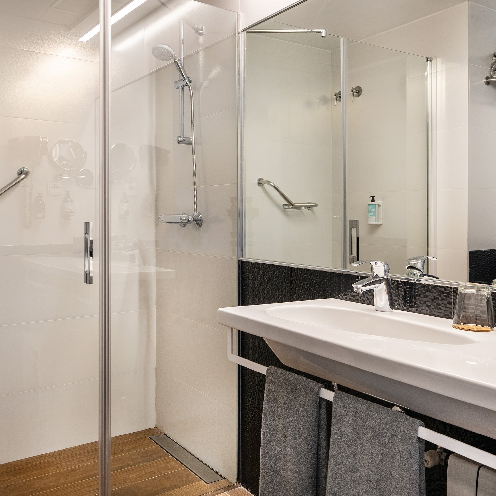 a bathroom with a shower and sink