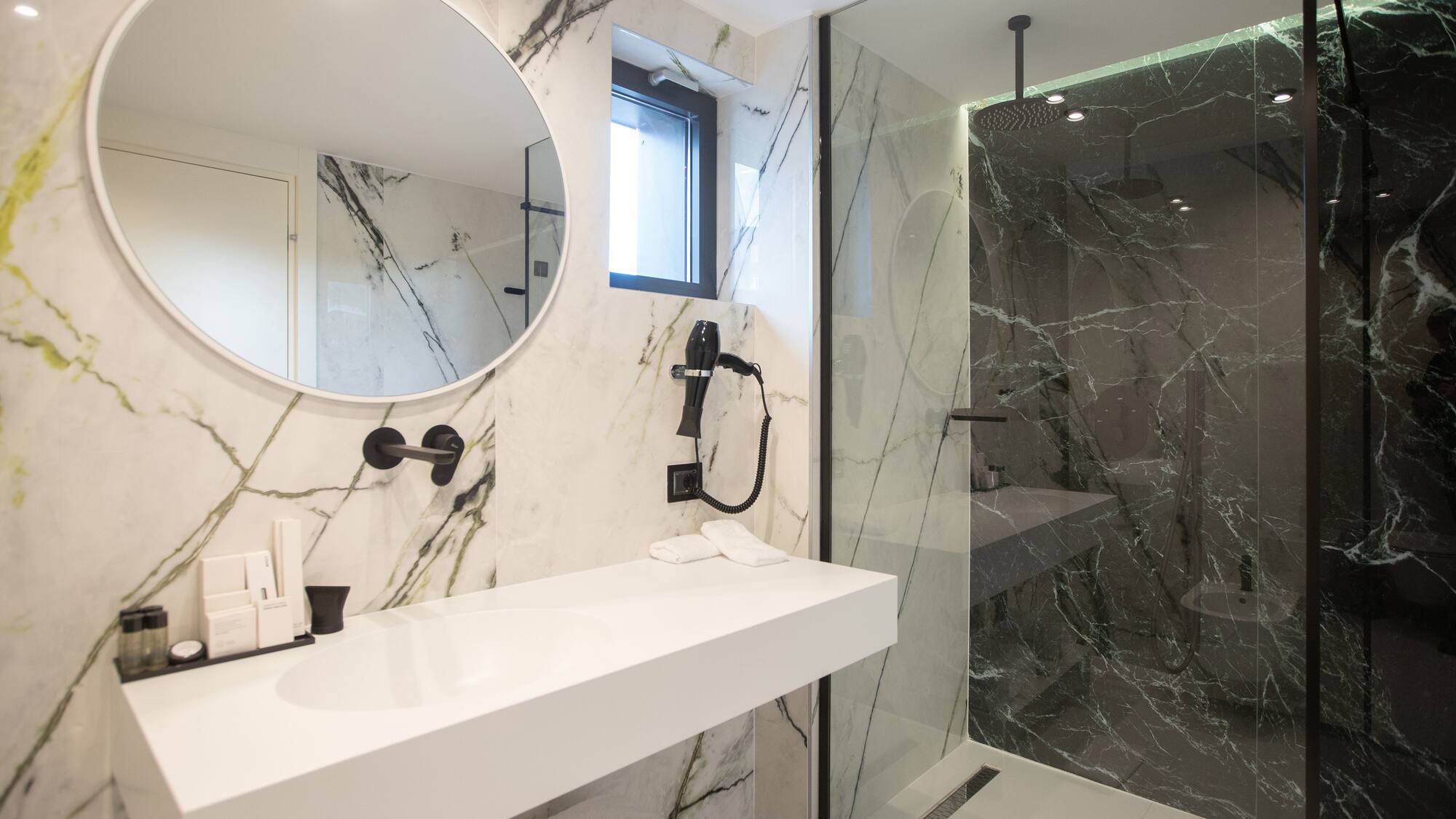 a bathroom with a mirror and a shower
