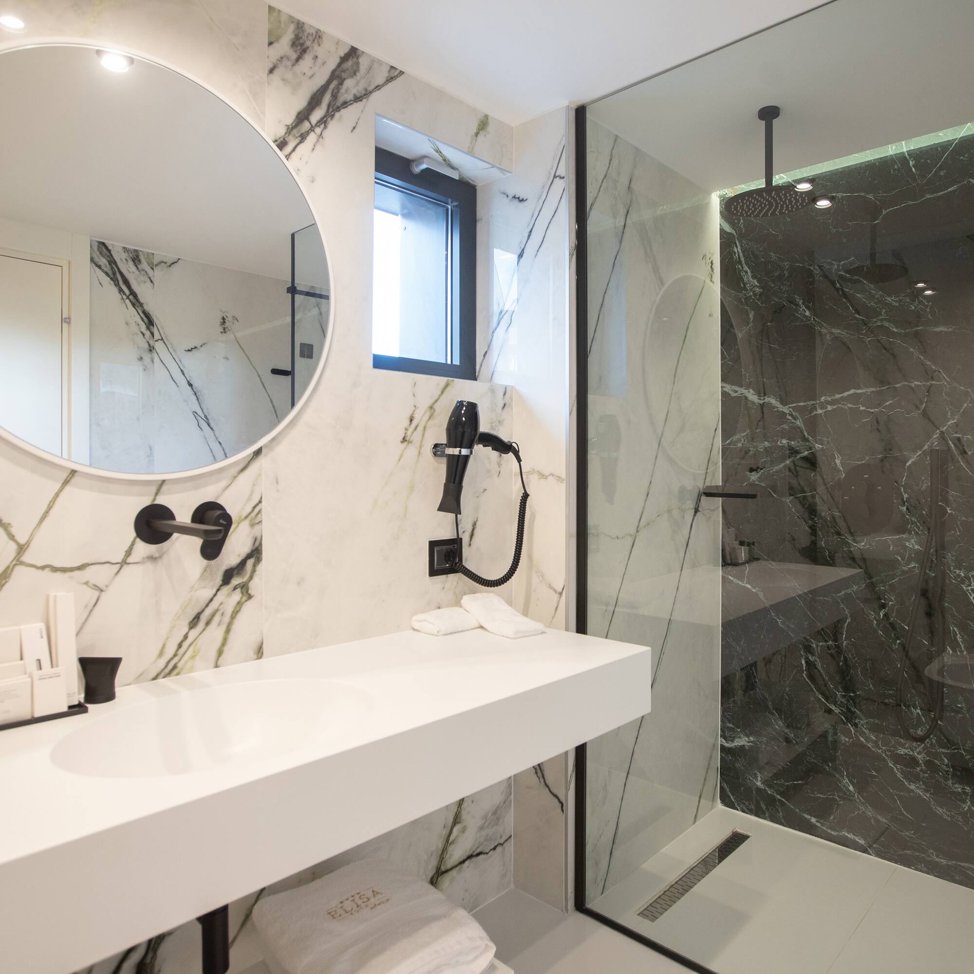 a bathroom with a mirror and a shower