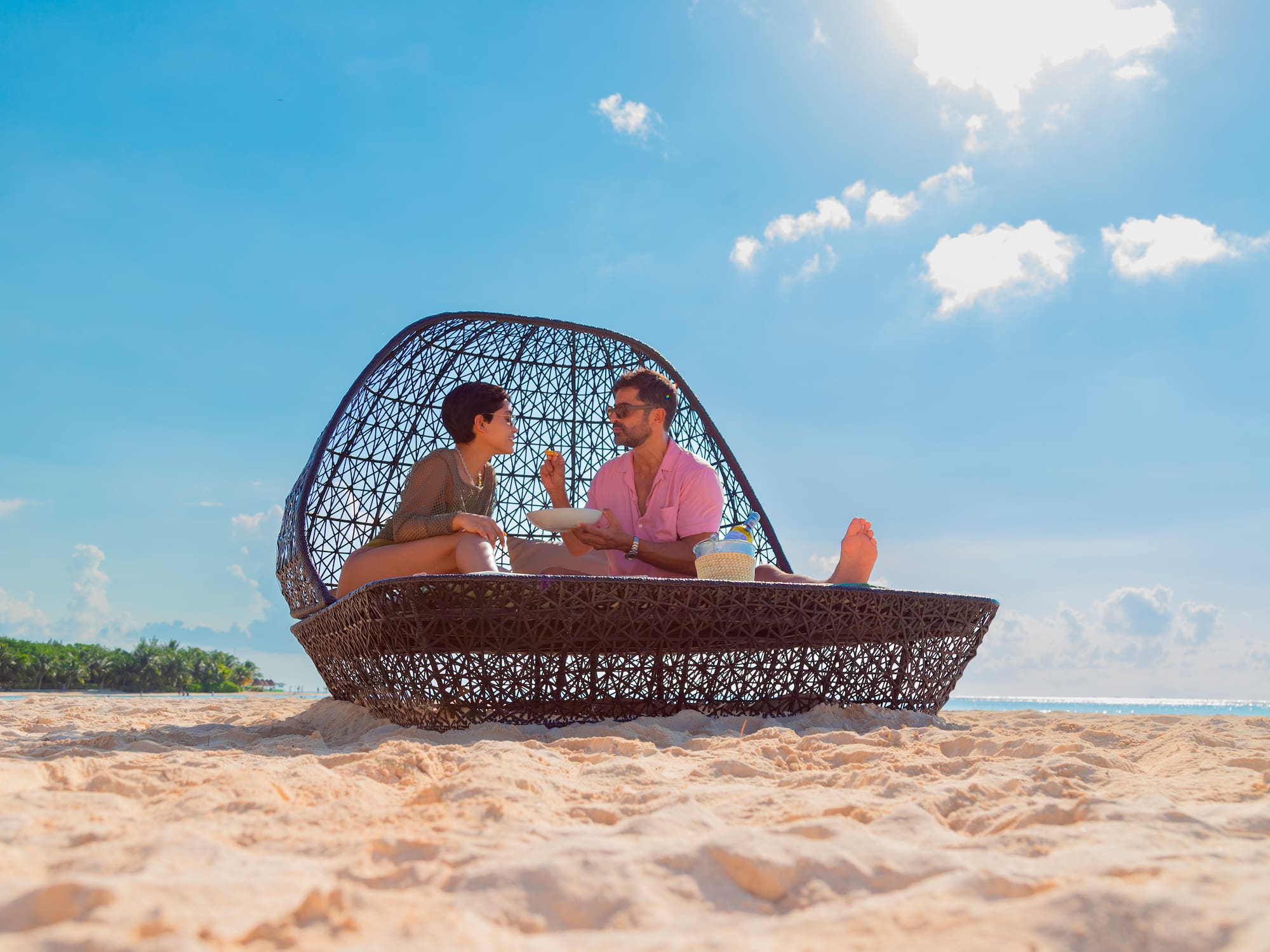 a man and woman sitting on a beach chair