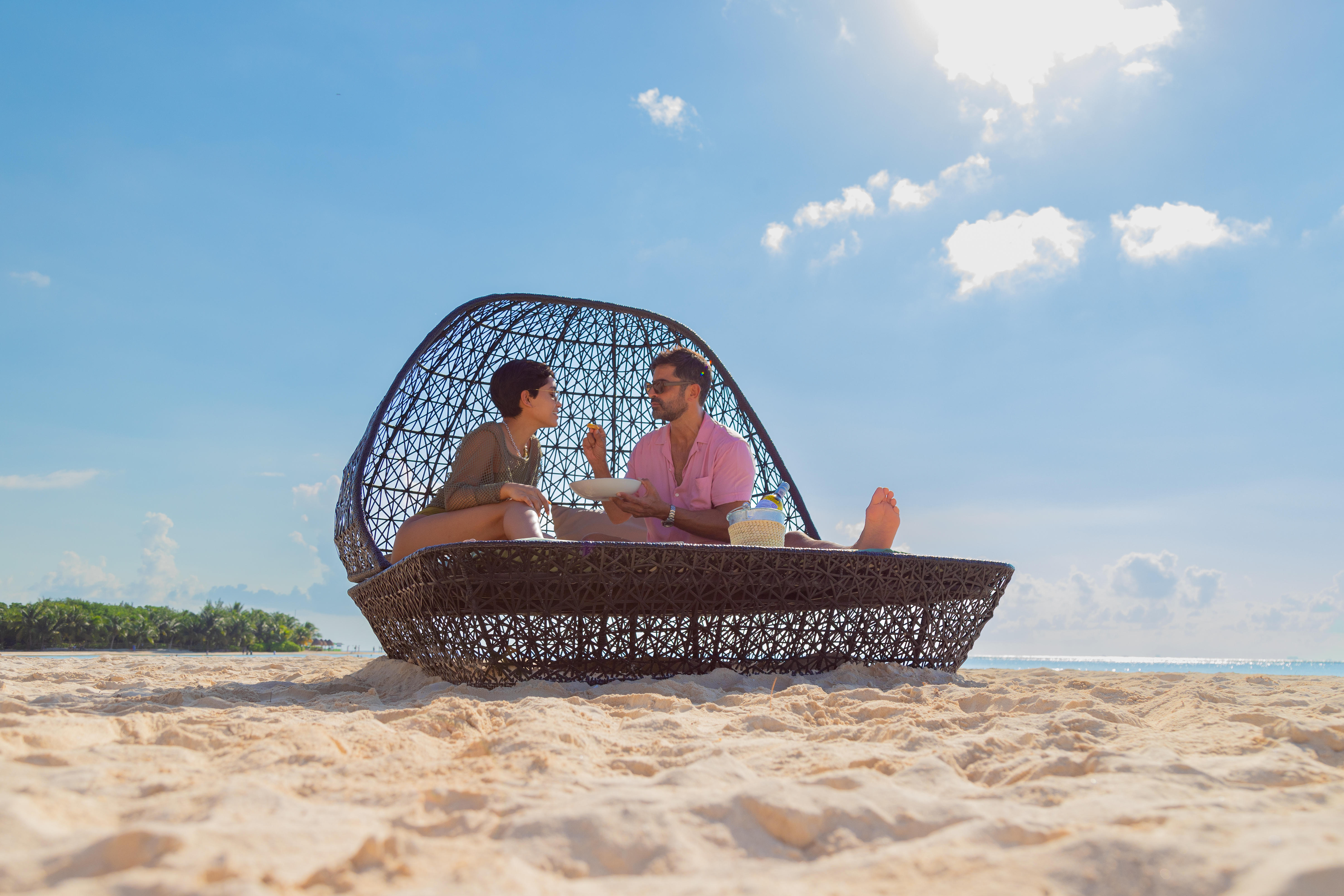 a man and woman sitting on a beach chair