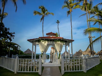 a man and woman standing under a gazebo