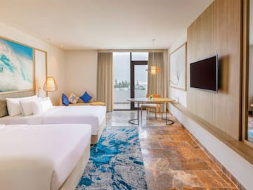 a room with two beds and a tv