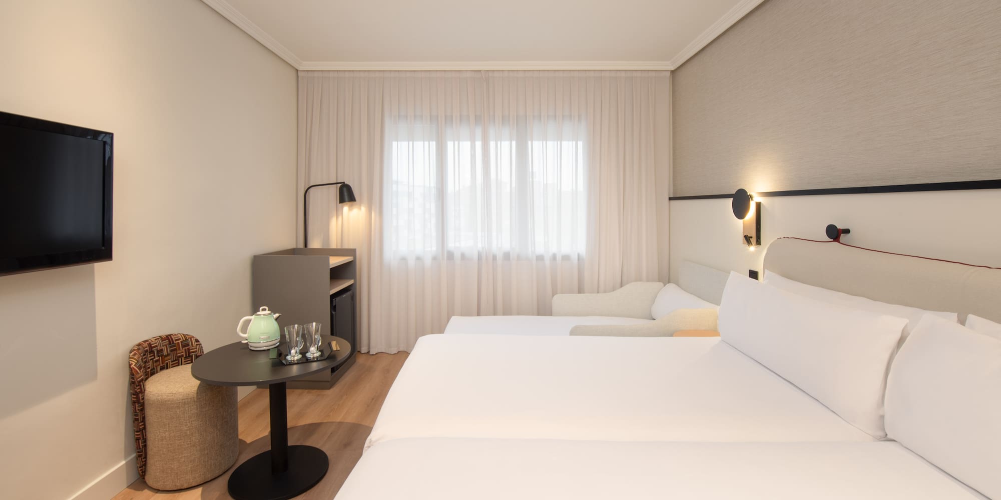 a room with two beds and a table