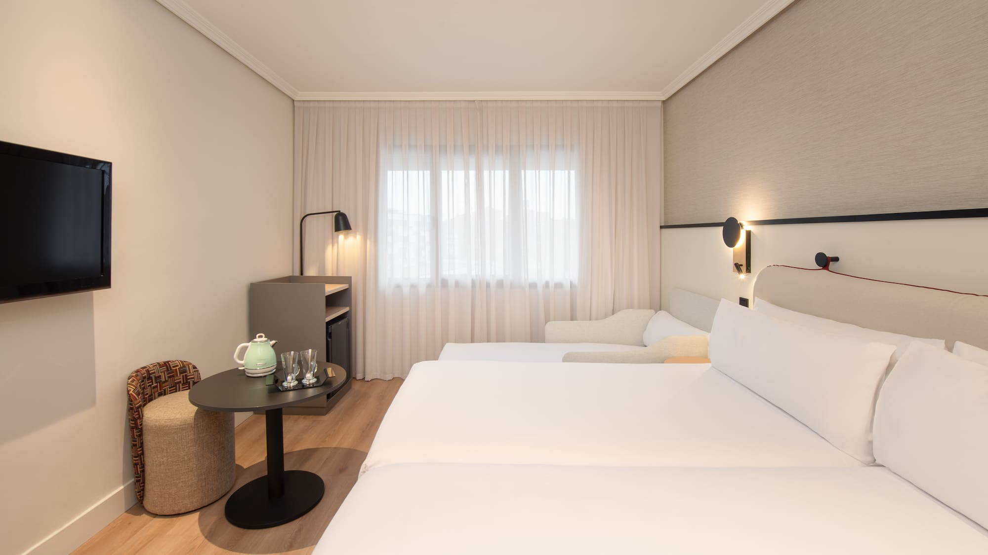 a room with two beds and a table