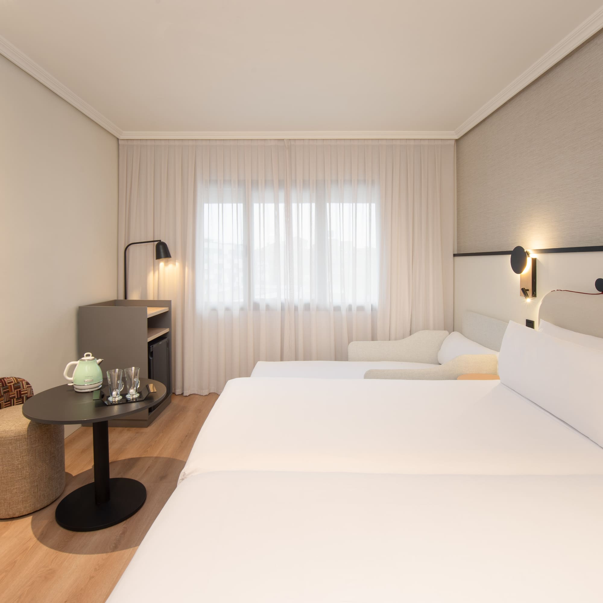 a room with two beds and a table