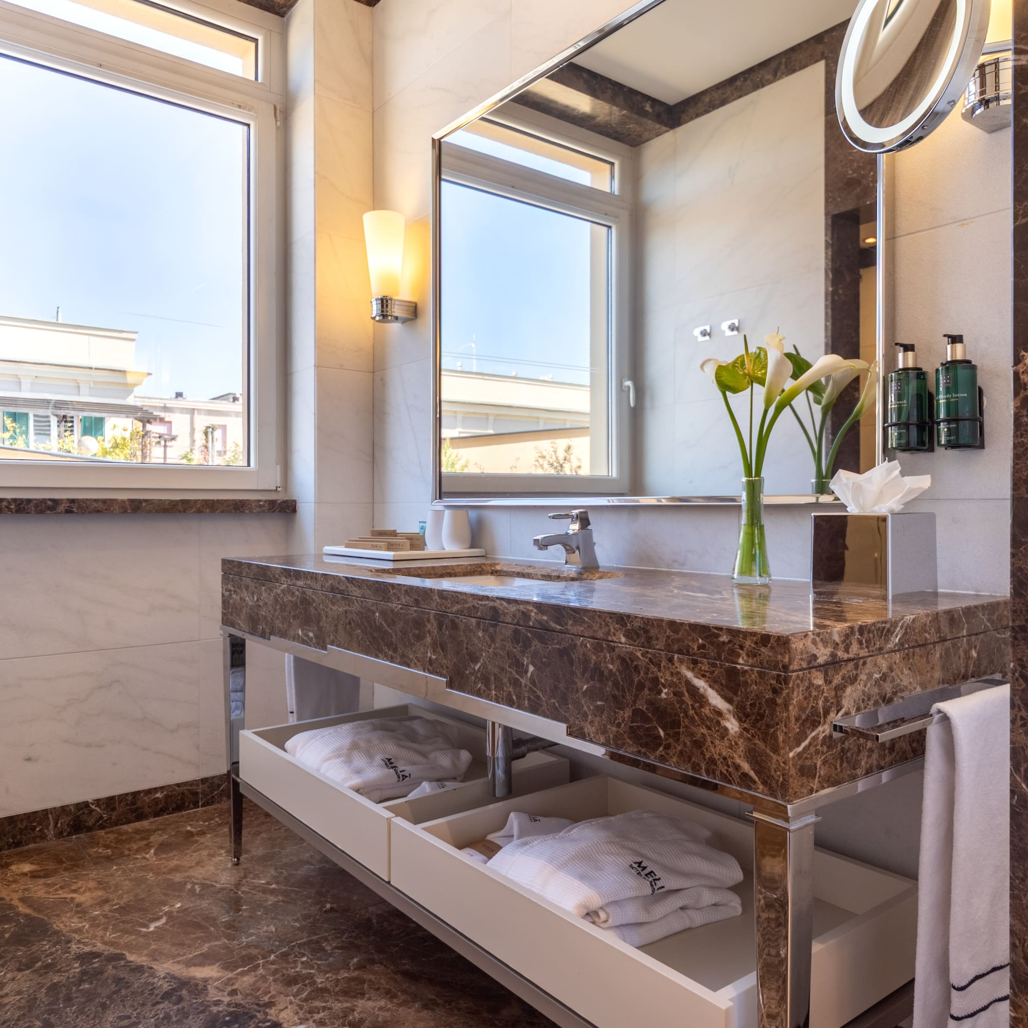 a bathroom with a marble countertop and a large mirror
