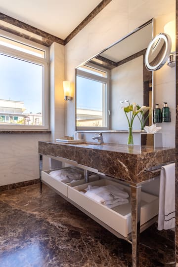 a bathroom with a marble countertop and a large mirror