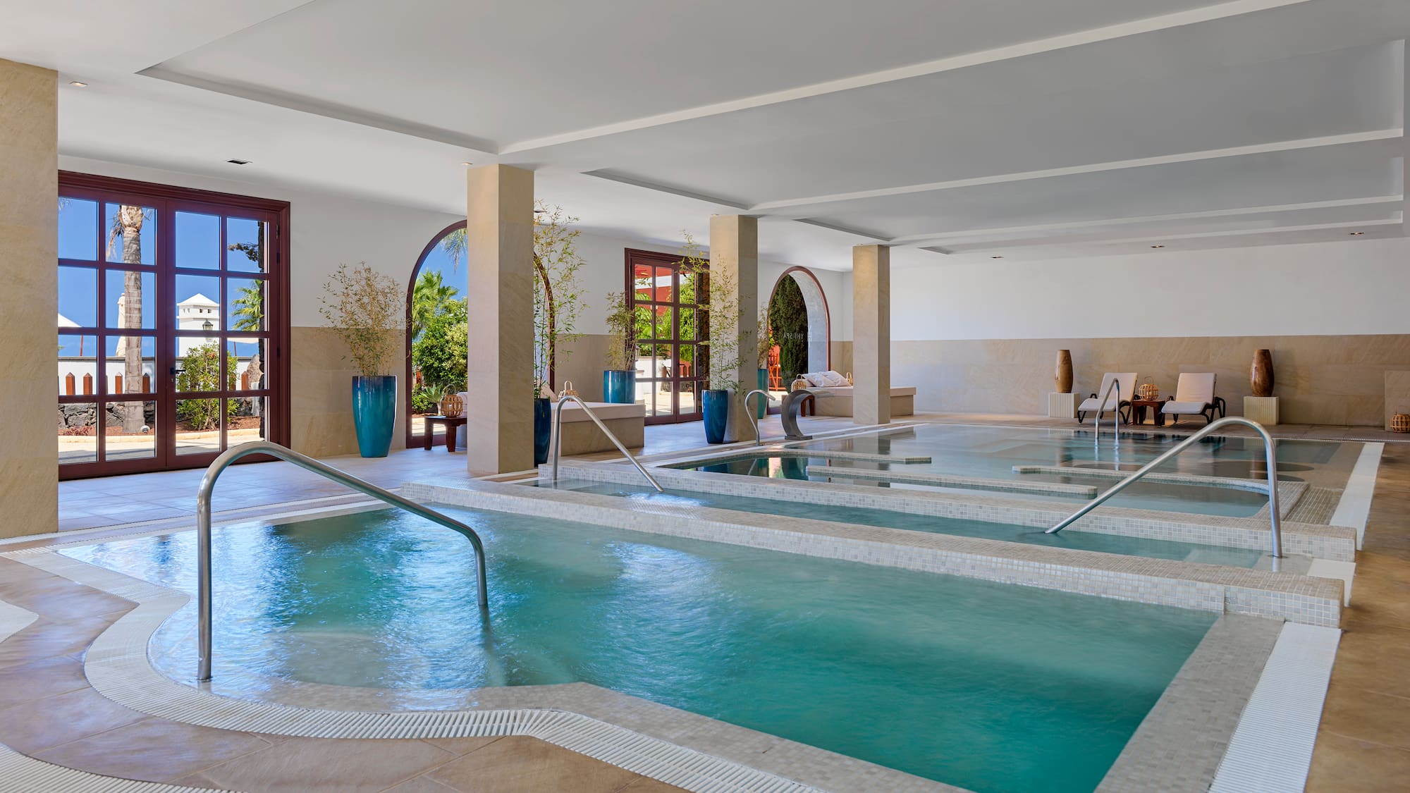 a large indoor pool with stairs and railings