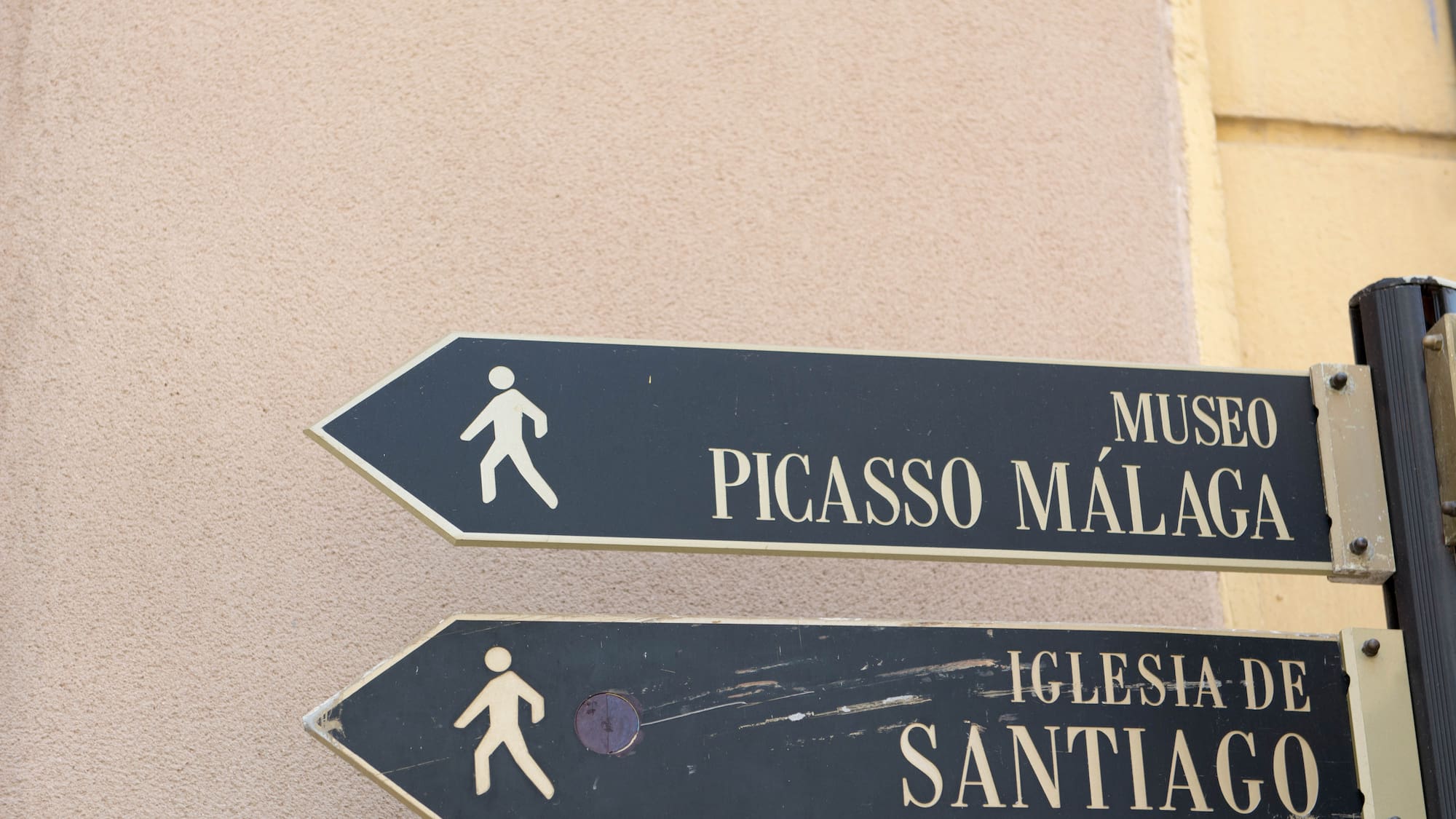a sign board with a person walking on it