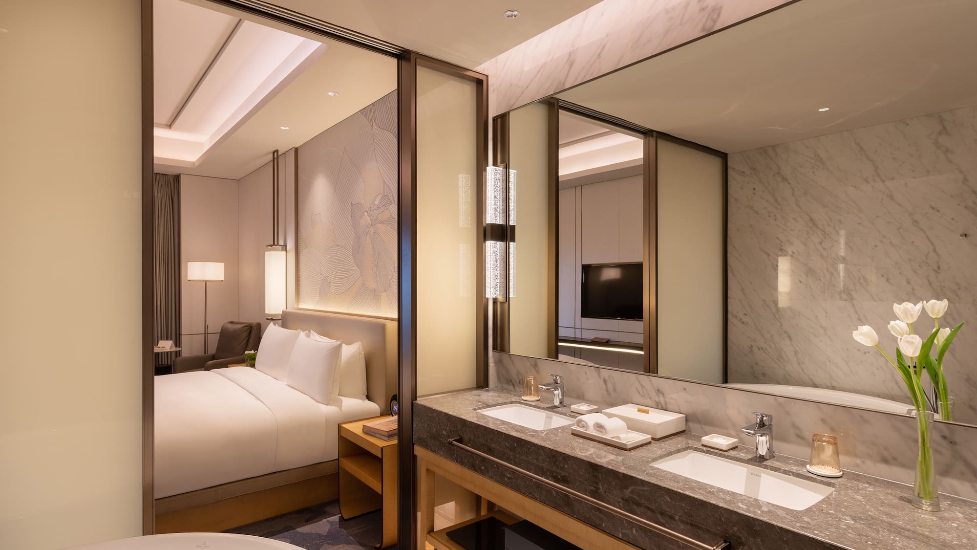 a bathroom with a bed and a mirror