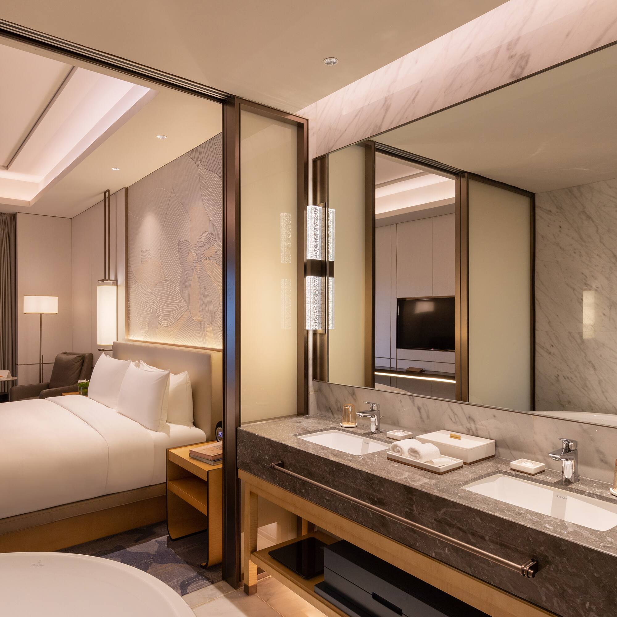 a bathroom with a bed and a mirror