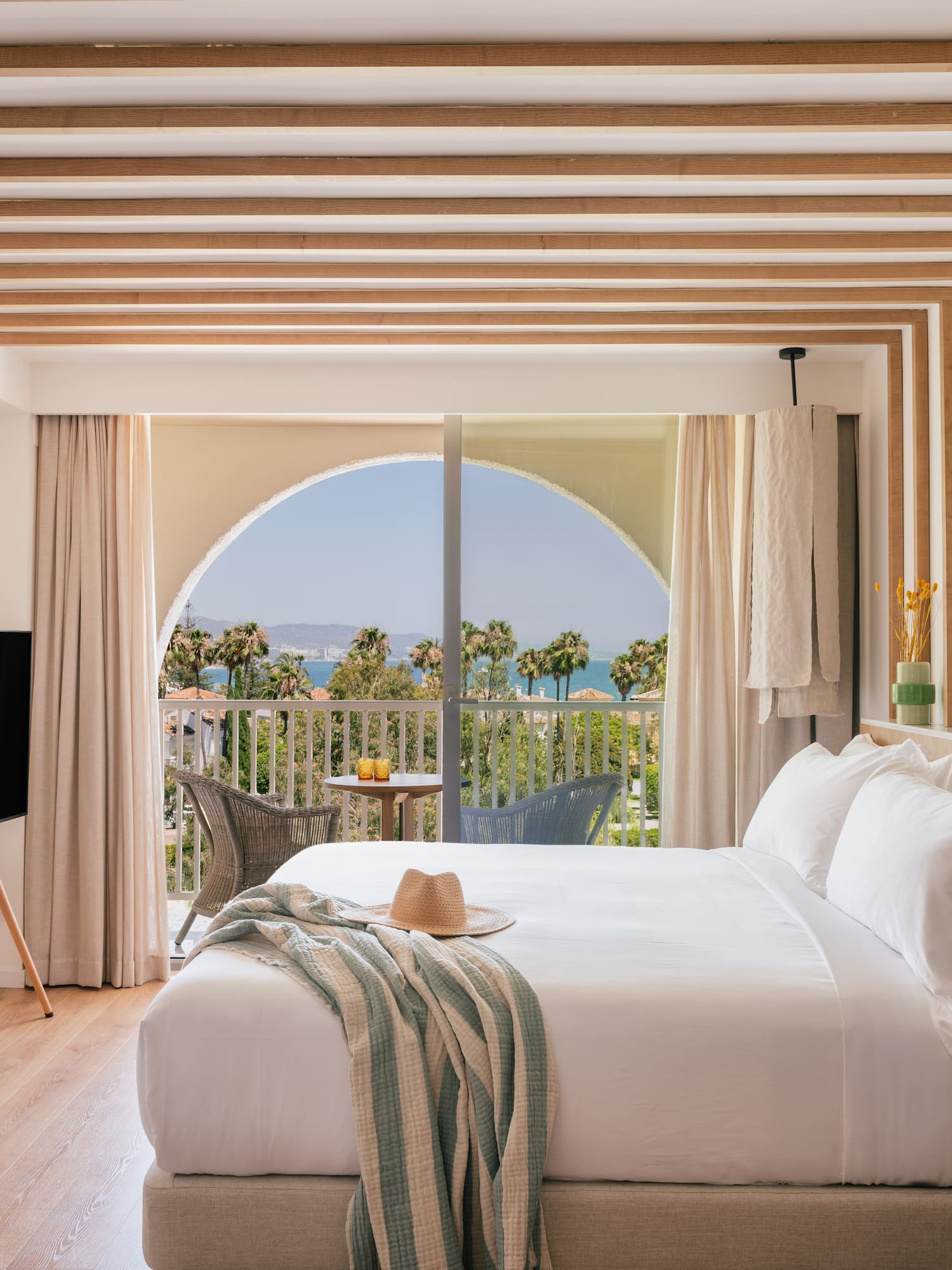 a bedroom with a large bed and a television