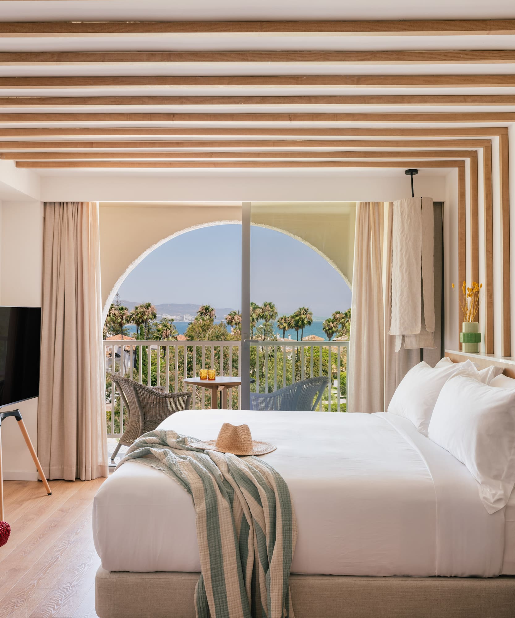 a bedroom with a large bed and a television