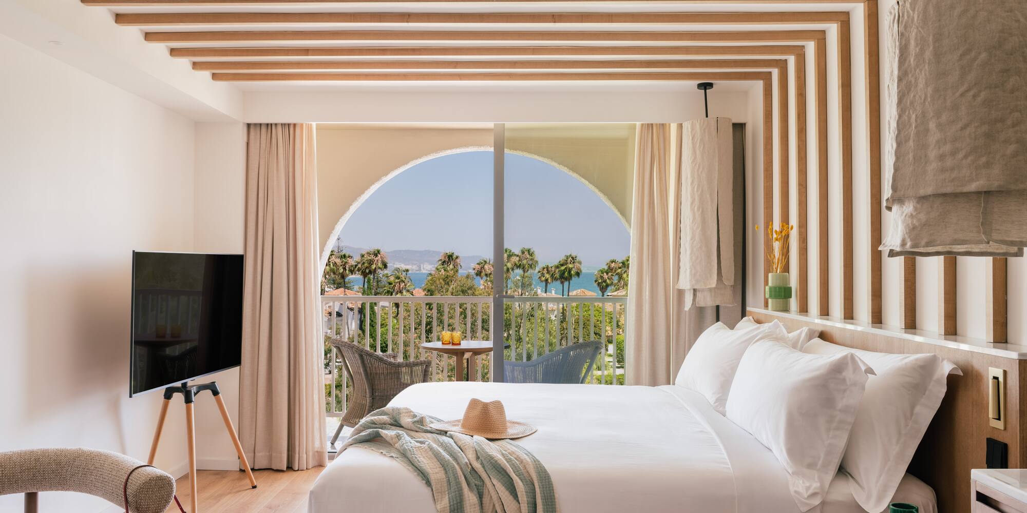 a bedroom with a large bed and a television