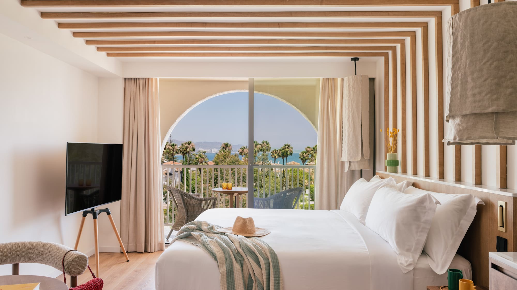 a bedroom with a large bed and a television