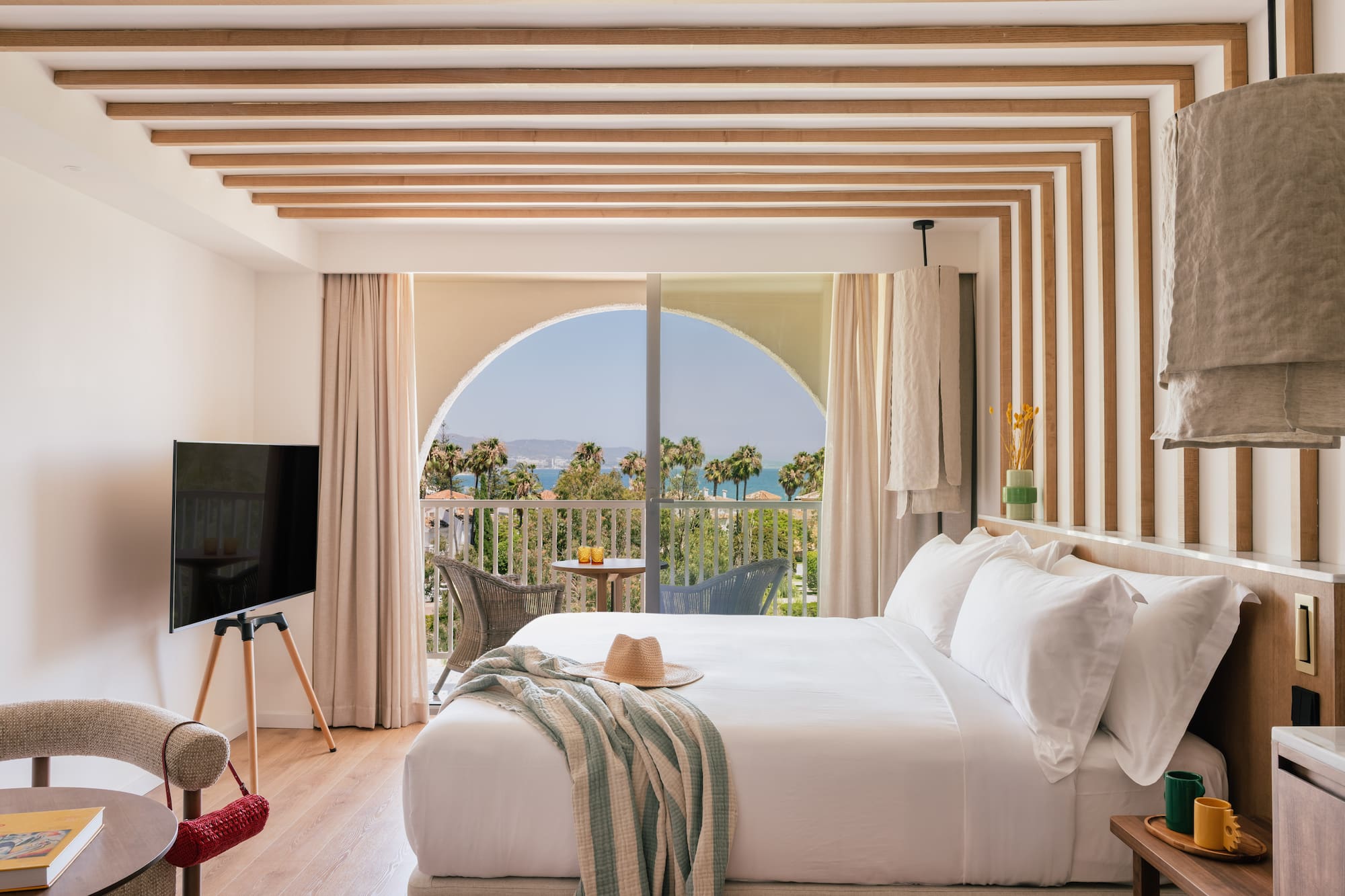 a bedroom with a large bed and a television