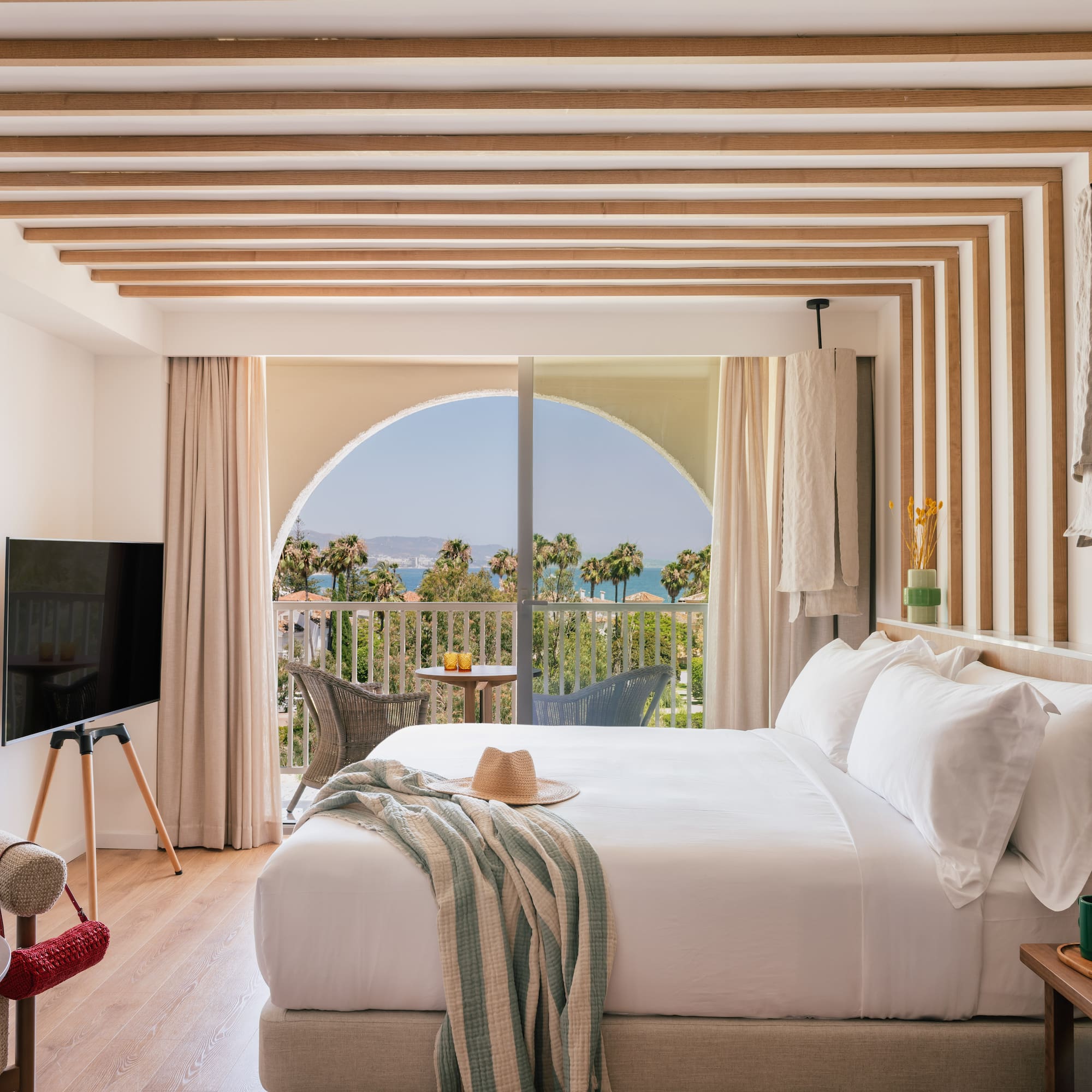 a bedroom with a large bed and a television