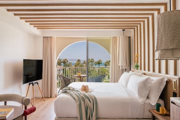 a bedroom with a large bed and a television