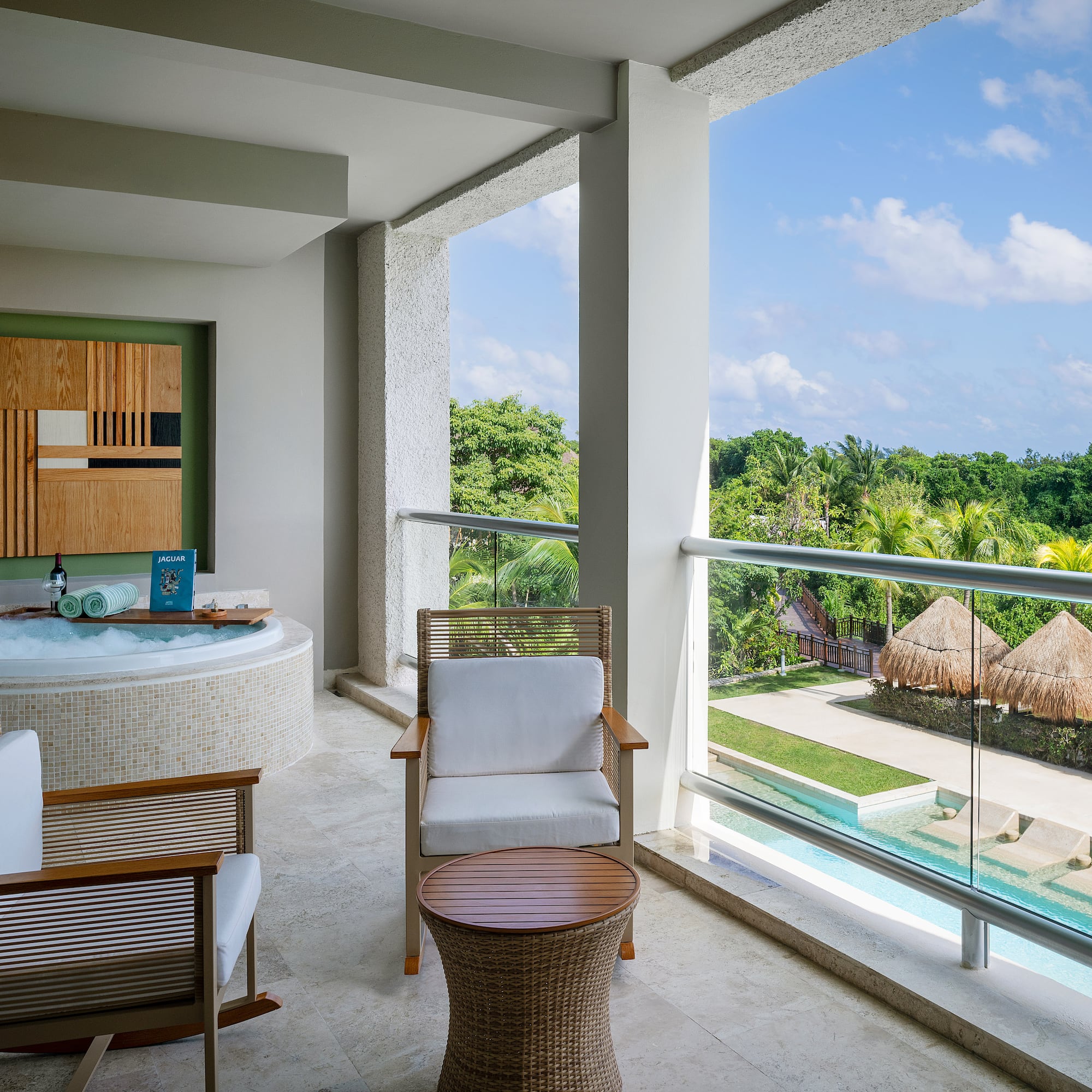 a jacuzzi with a view of the pool and a deck