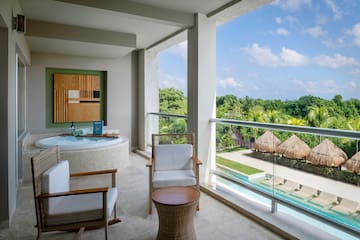 a jacuzzi with a view of the pool and a deck